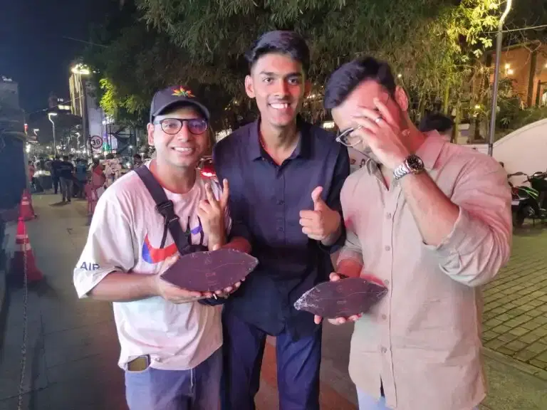 Guests holding DZIR chocolate at an evening event